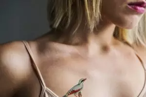 close up of tattoo on the chest of a woman pubdgn compressed